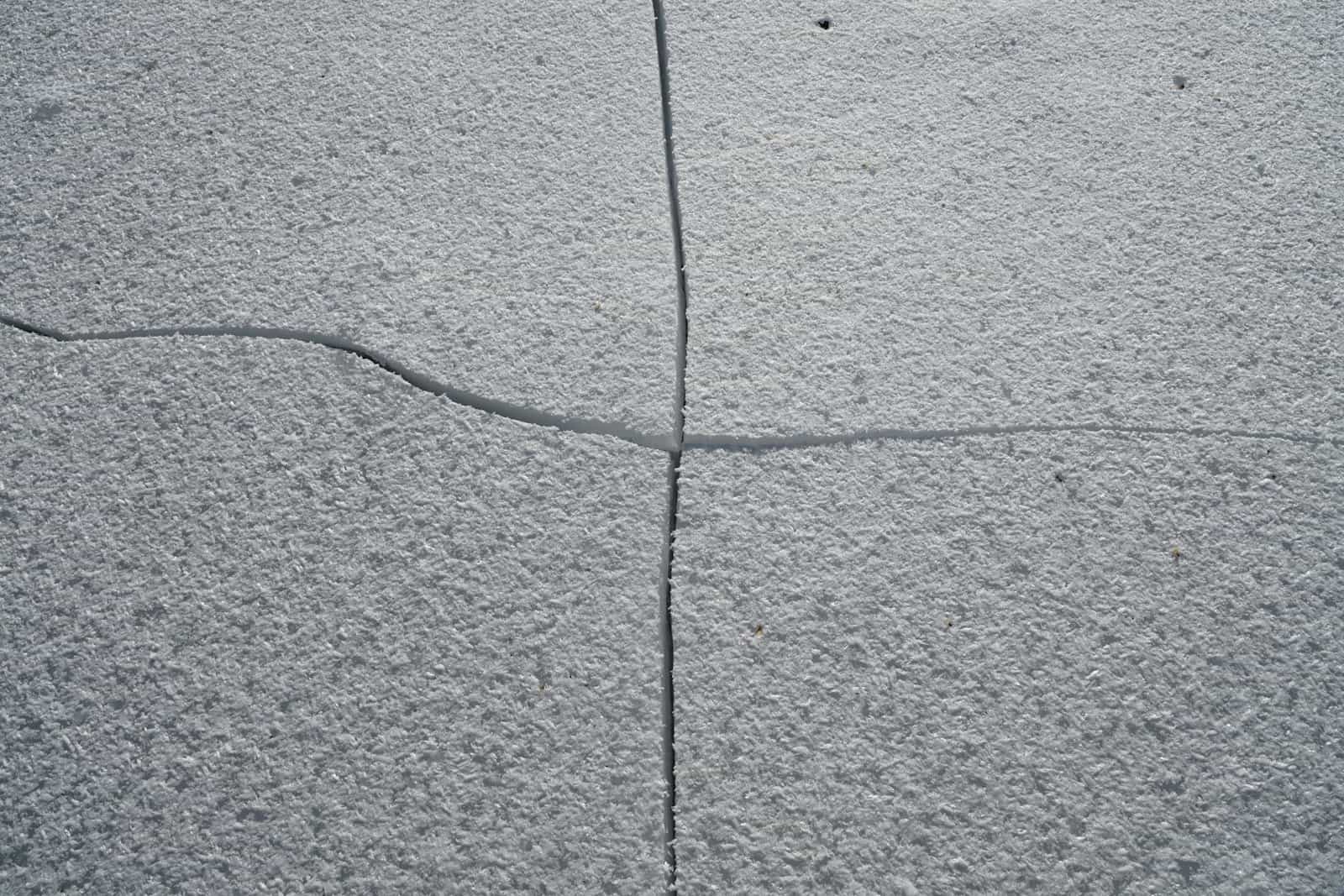 Cracked and spalled concrete slab surface before restoration work