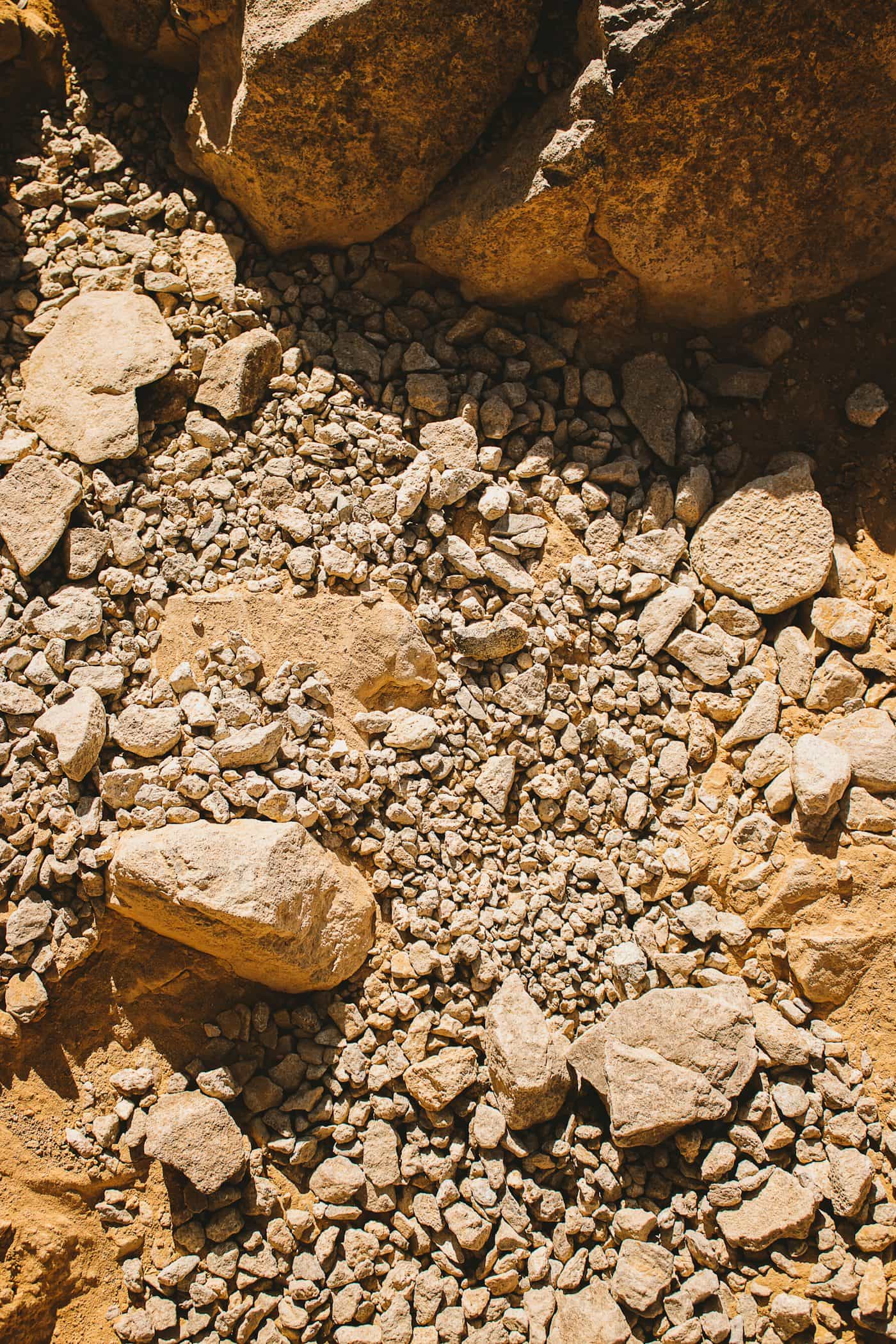 Close-up of natural aggregate stone mix used in a resin-bound overlay system