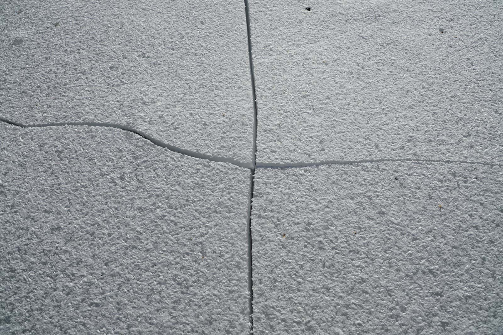 Cracked and spalled concrete slab surface before restoration work