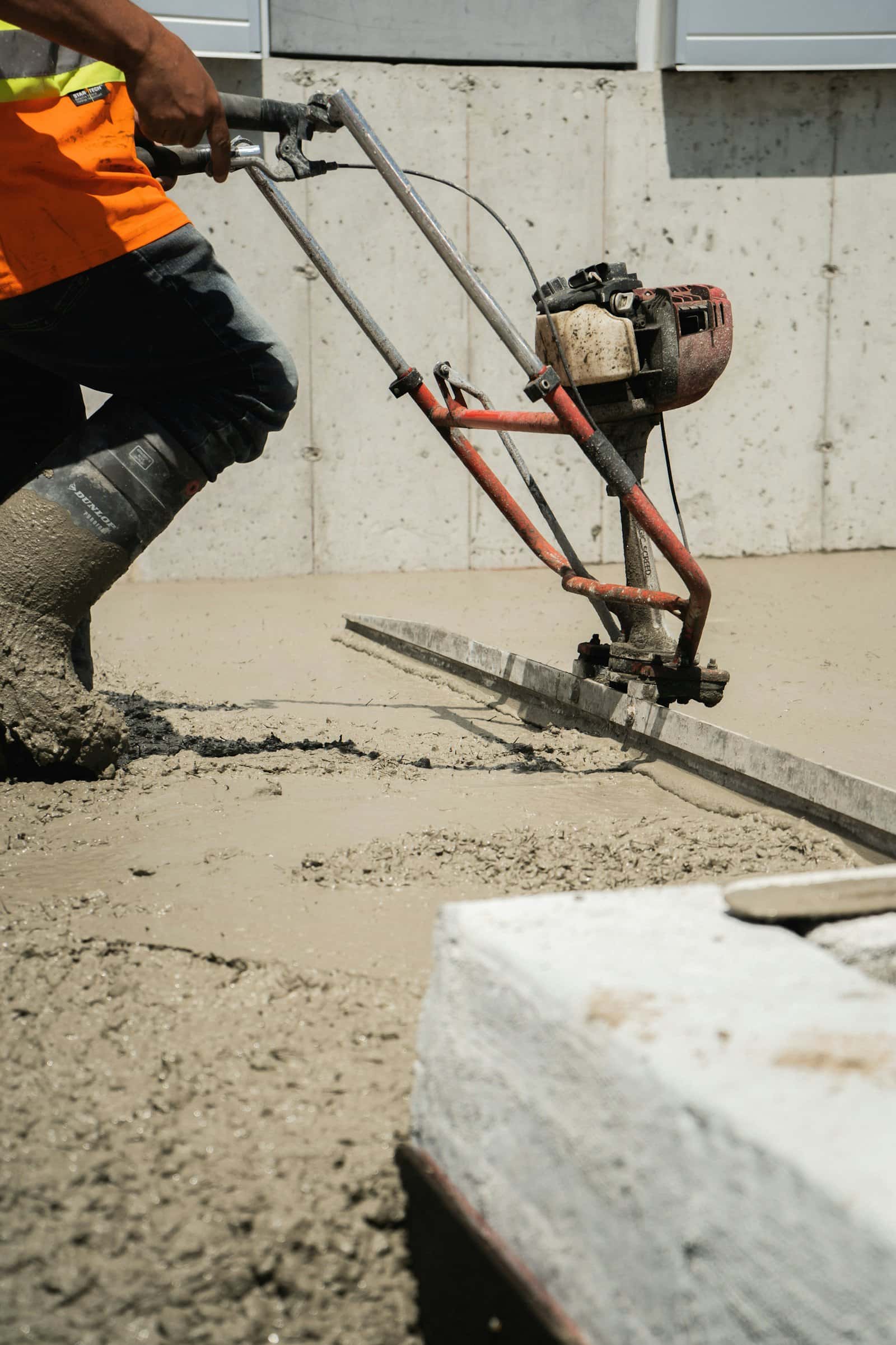 Concrete being placed through a pump line into formwork