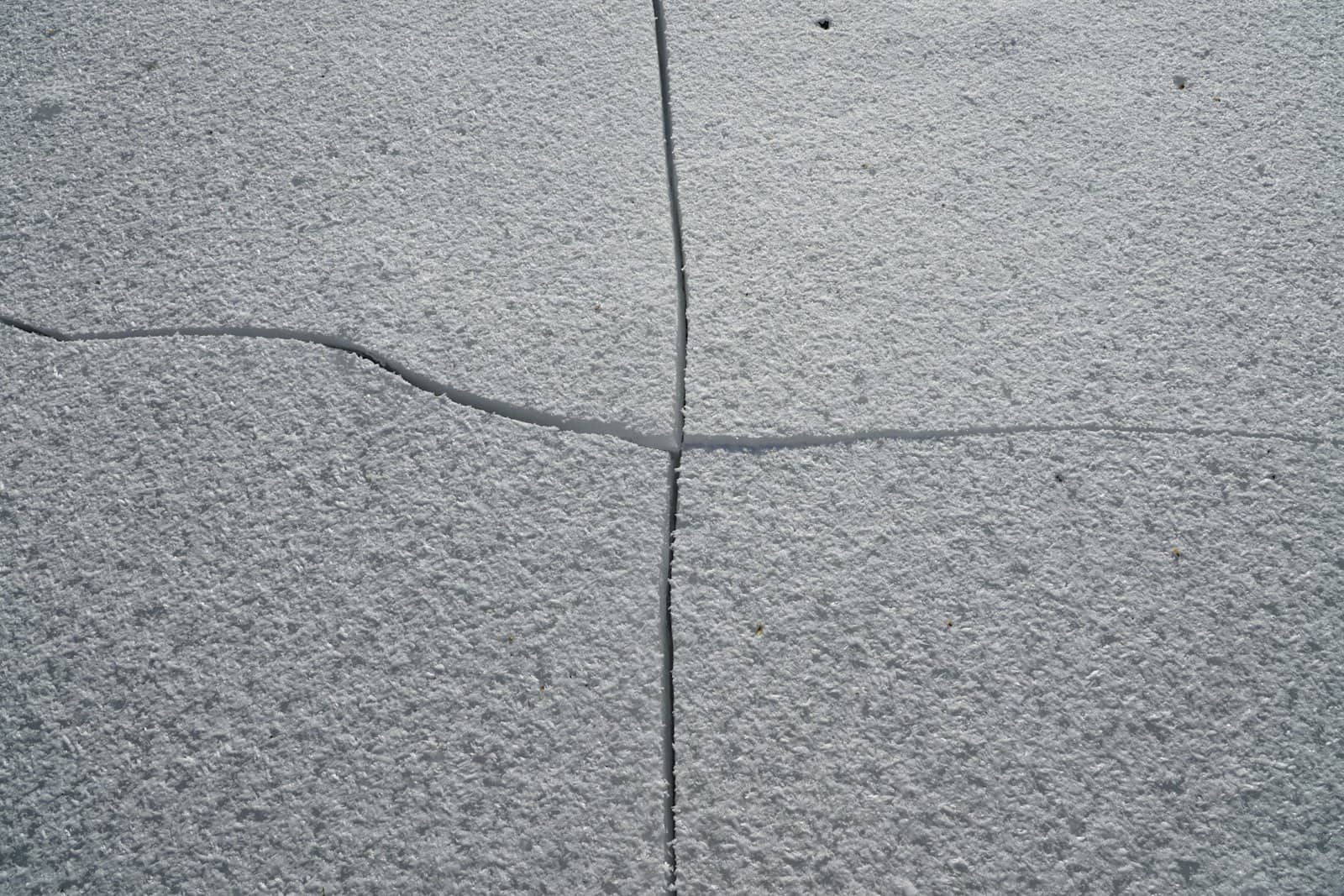 Cracked and spalled concrete slab surface before restoration work