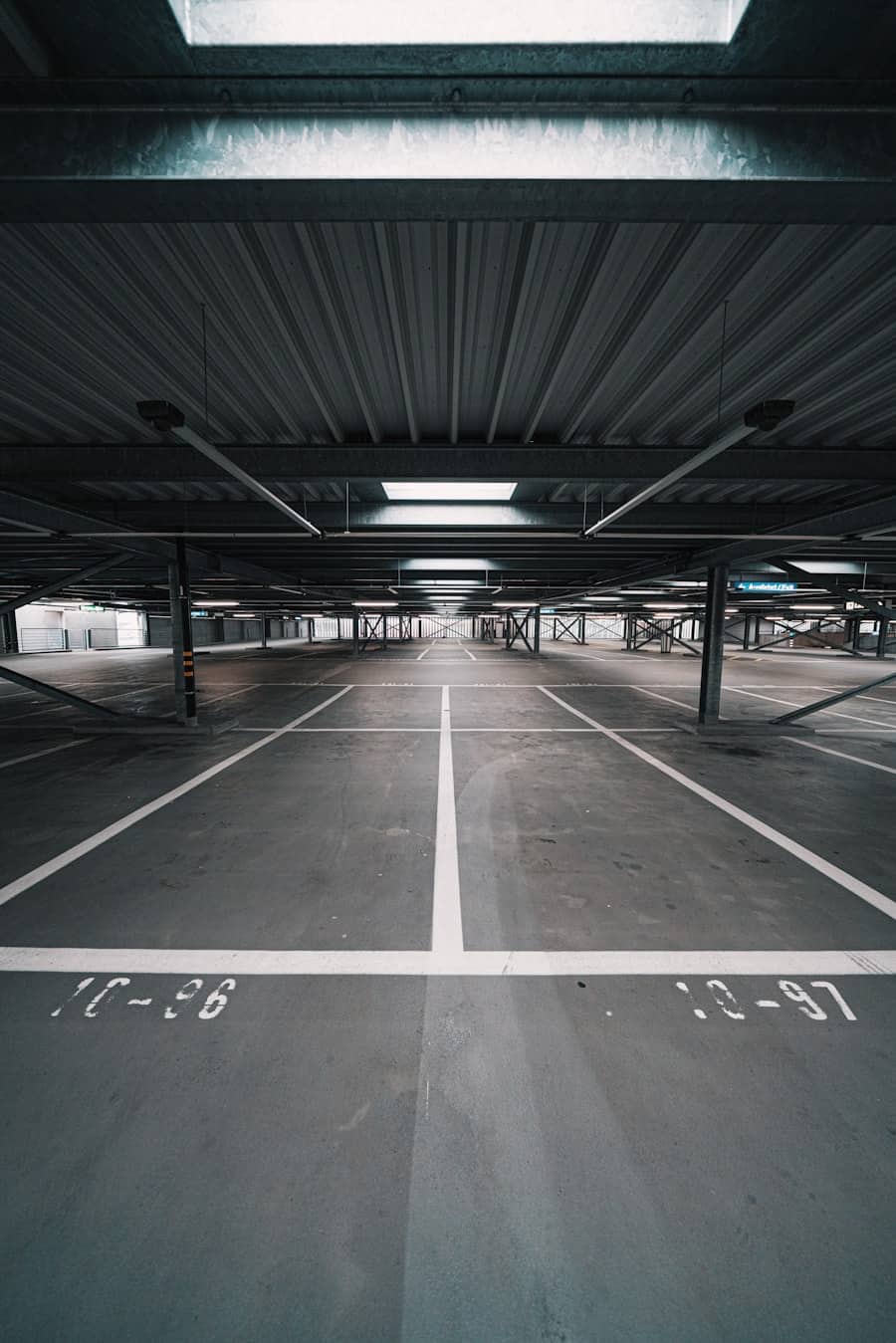 Commercial parking structure with concrete pavement and marked stalls