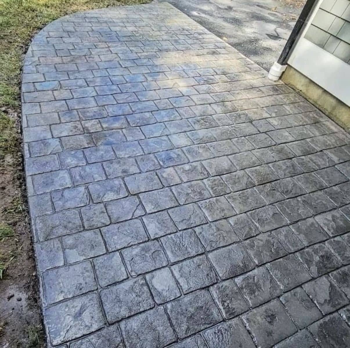 Stamped concrete walkway in a blue-gray cobblestone pattern