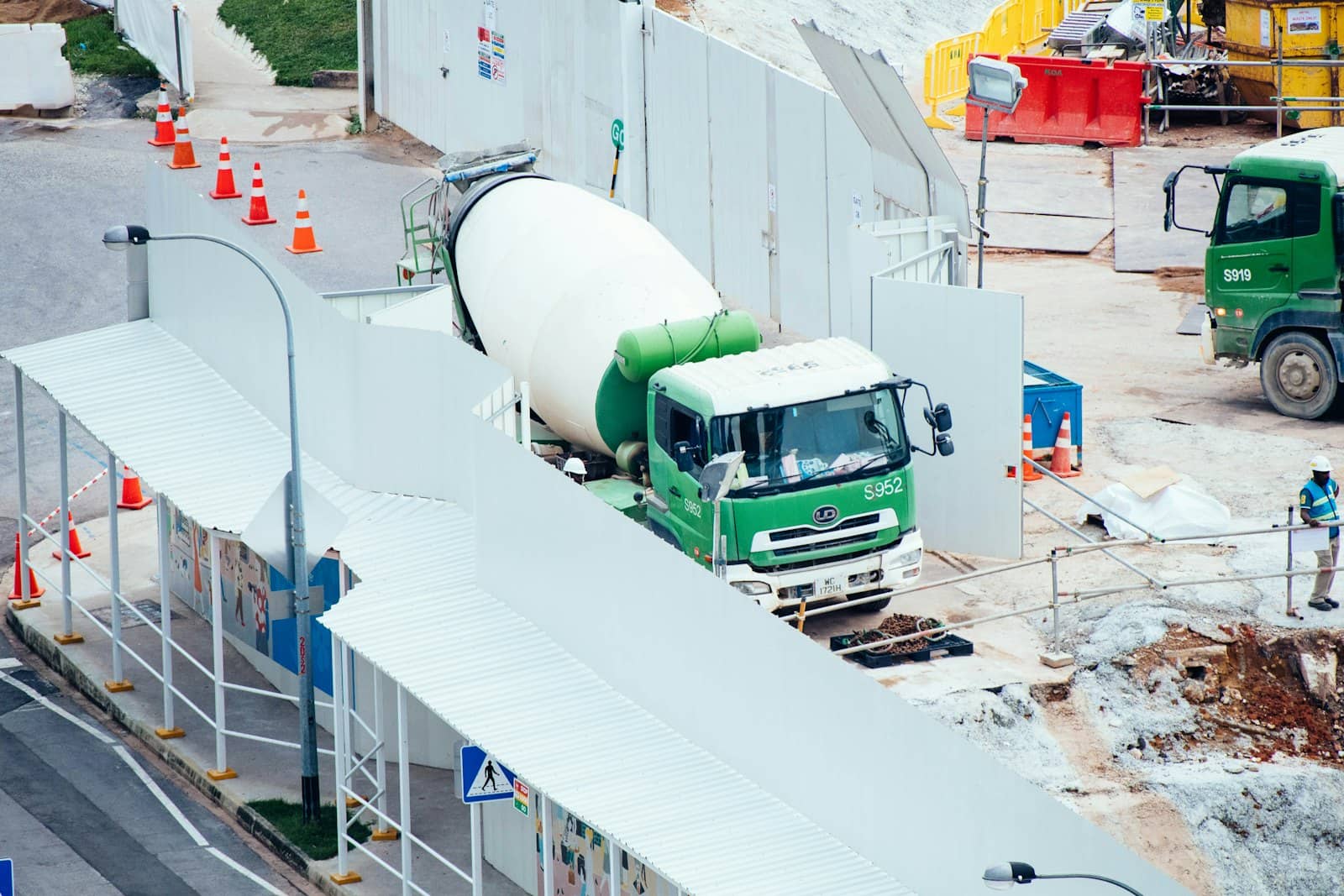 Ready-mix truck feeding a concrete pump on a residential street