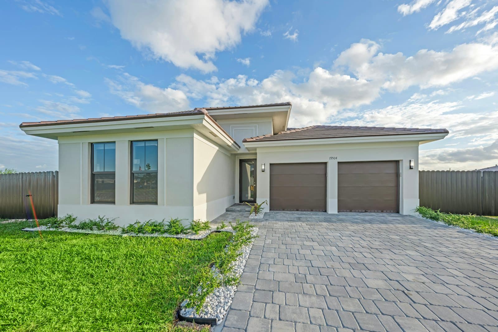 Modern home with a clean, freshly finished concrete driveway and garage
