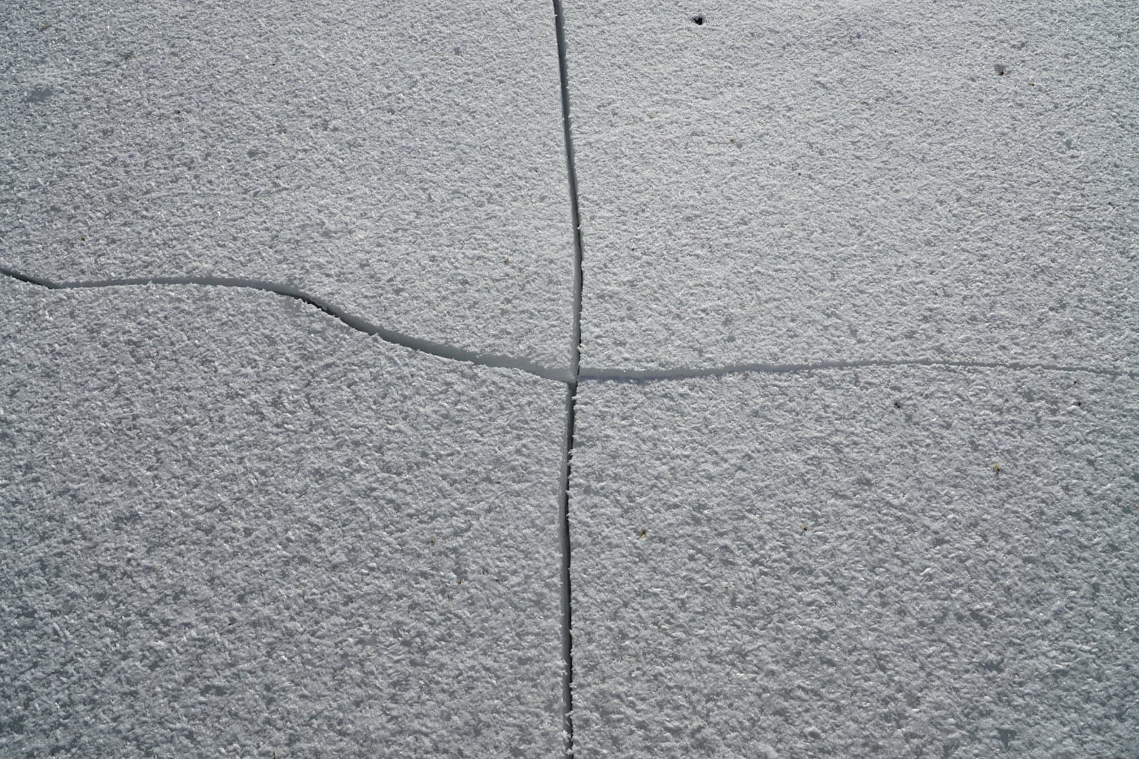 Wide crack opening across a ground-level concrete slab