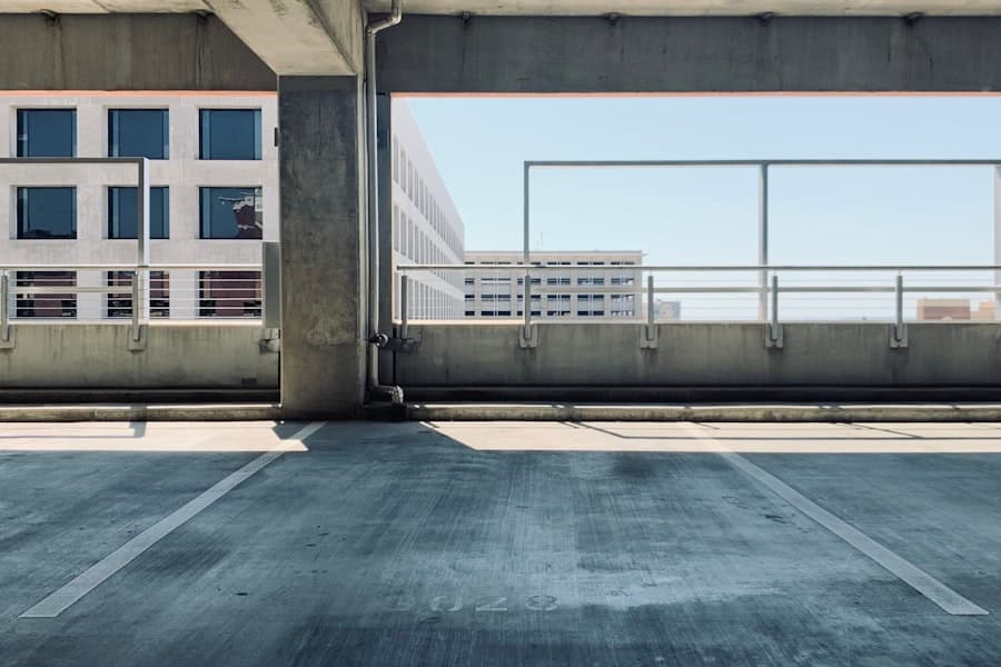 Daylight view of a commercial parking garage's concrete structure and pavement