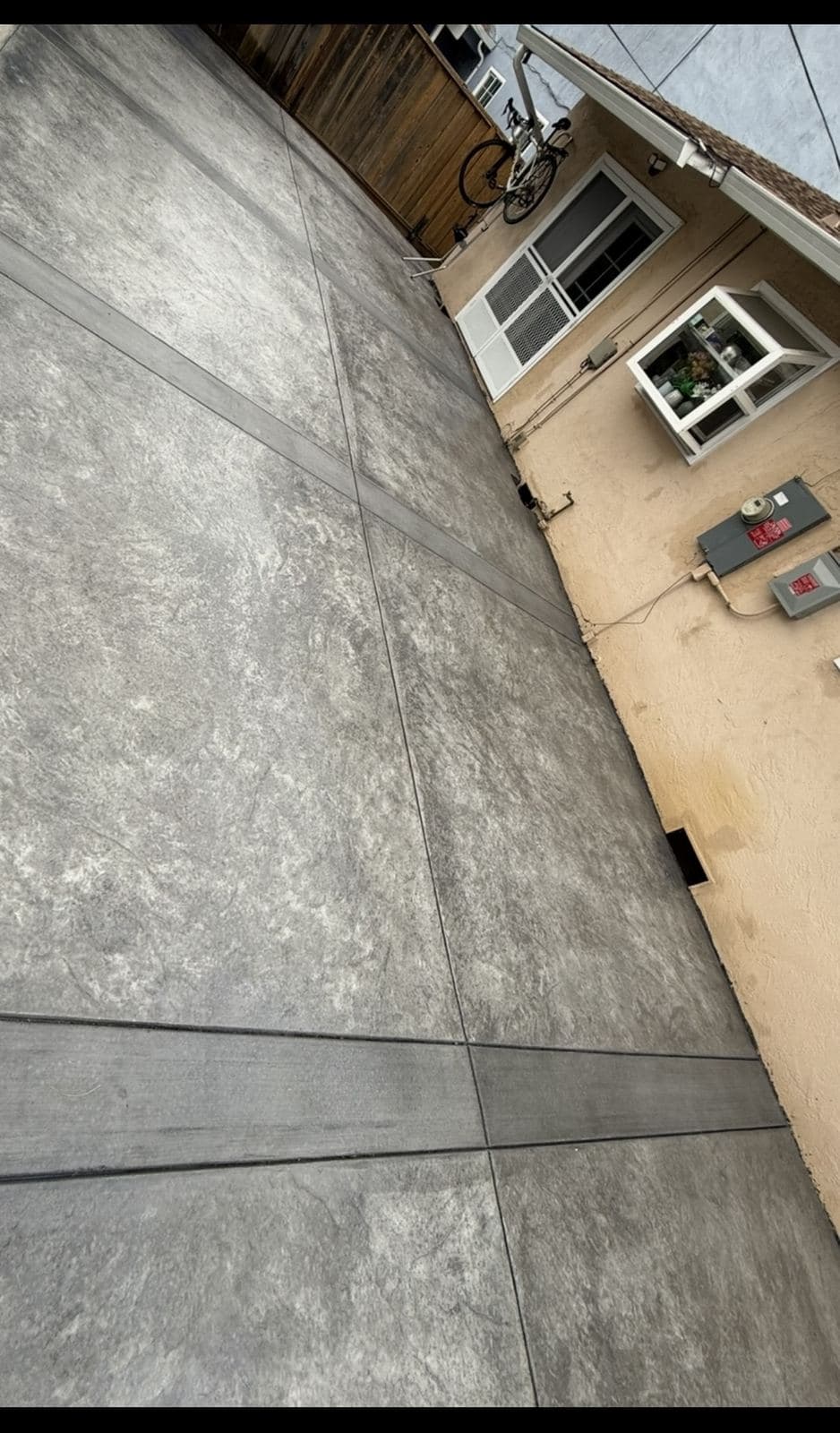 Finished concrete patio along the back of a stucco home
