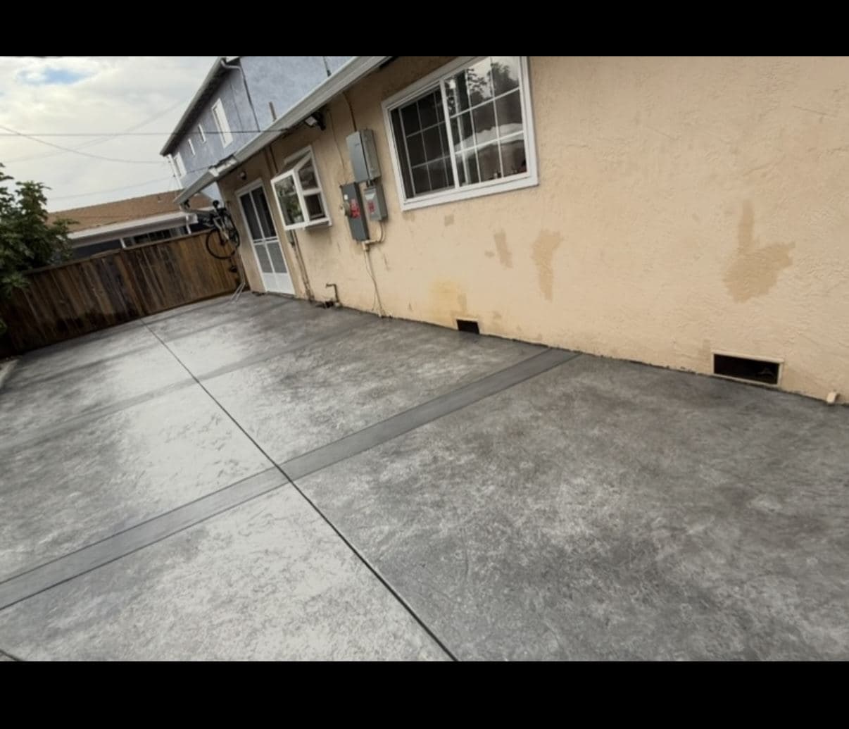 Broom-finished concrete patio along the back of a Bay Area home