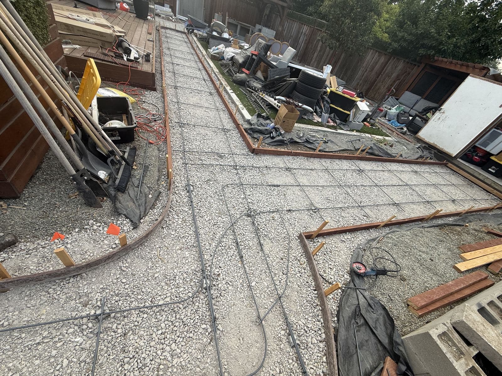 Wood forms and rebar grid set out for a curved walkway pour