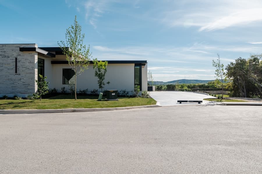 Modern house with a green lawn and a clean concrete driveway