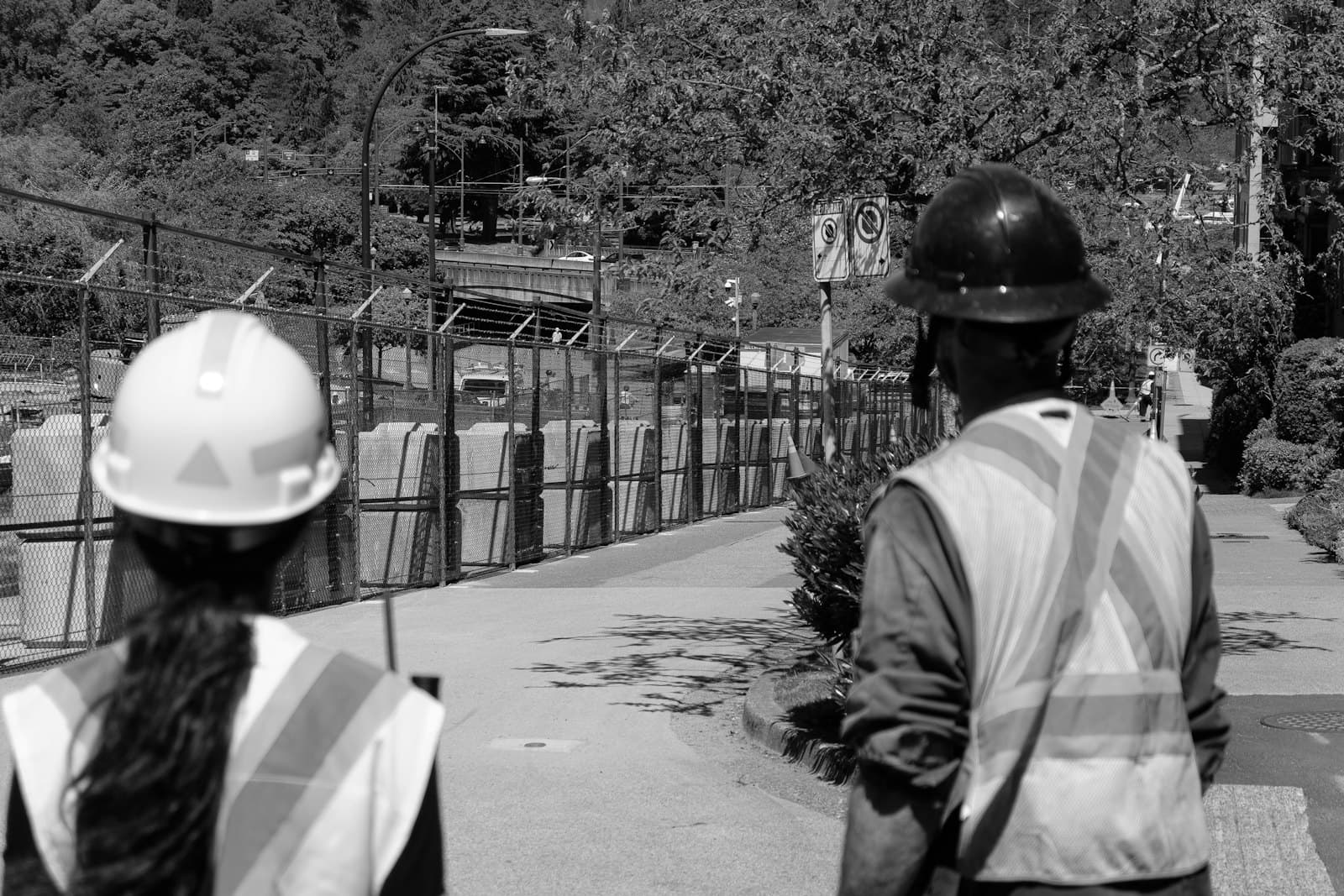 Two concrete workers in hard hats and high-visibility vests on site
