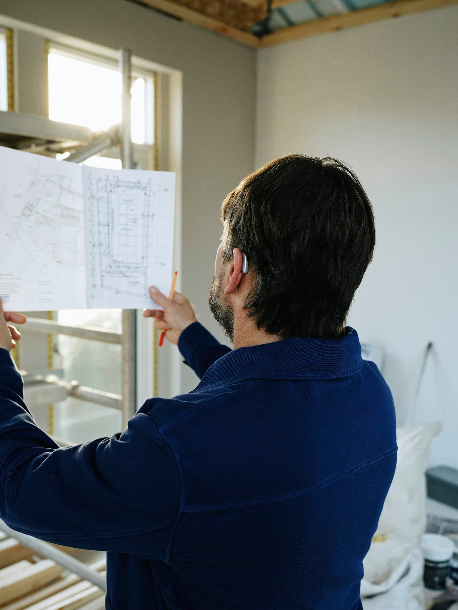 Site supervisor reviewing construction drawings on a project