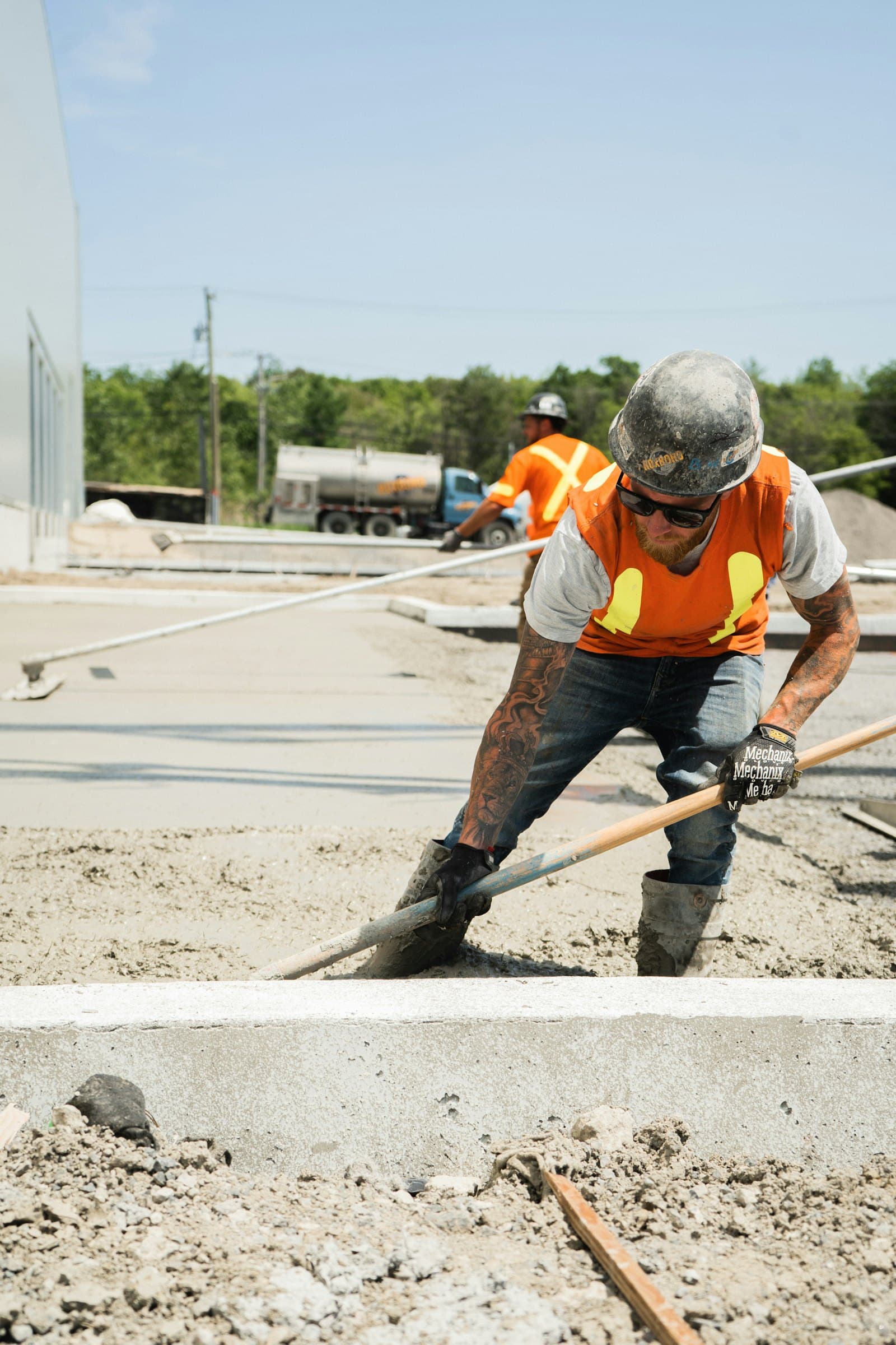 Concrete crew raking and placing a fresh driveway slab
