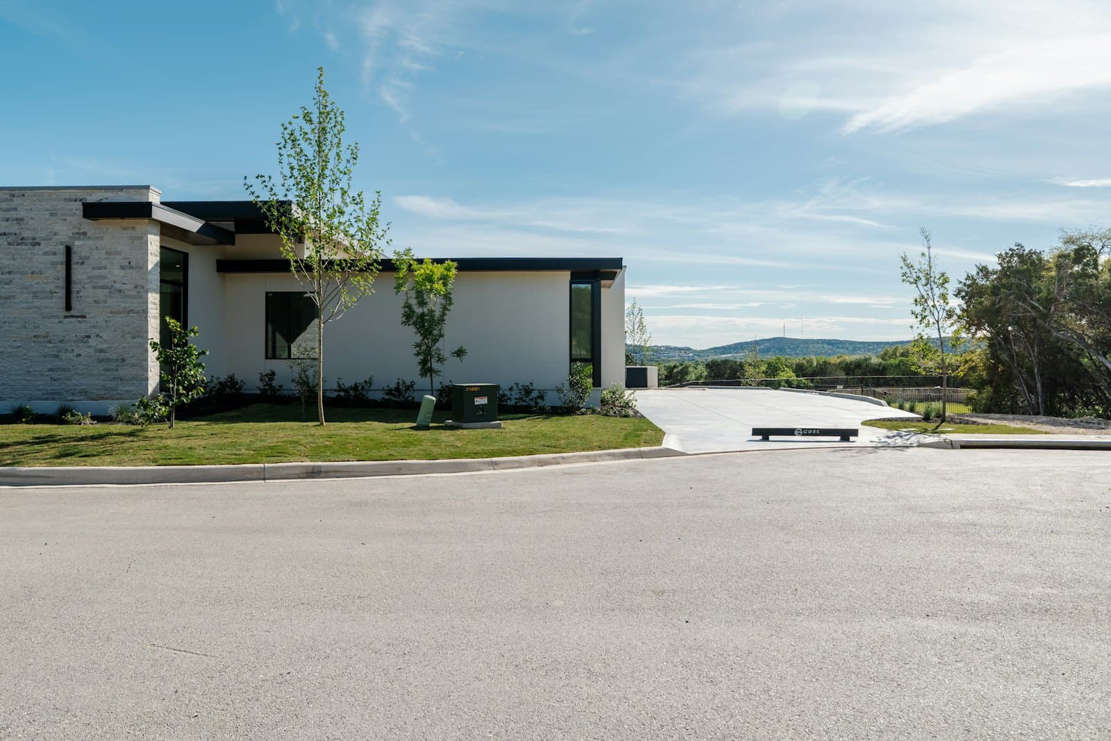 Modern home with a wide, freshly finished concrete driveway