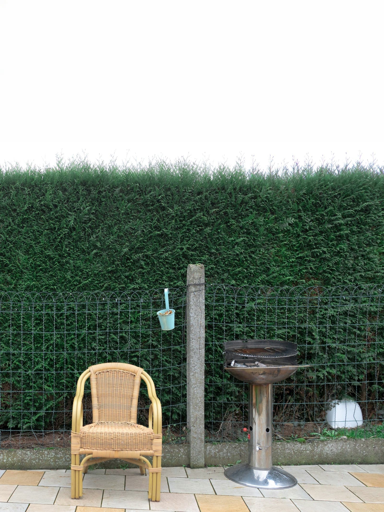 Outdoor living patio with seating and dining areas on a concrete surface