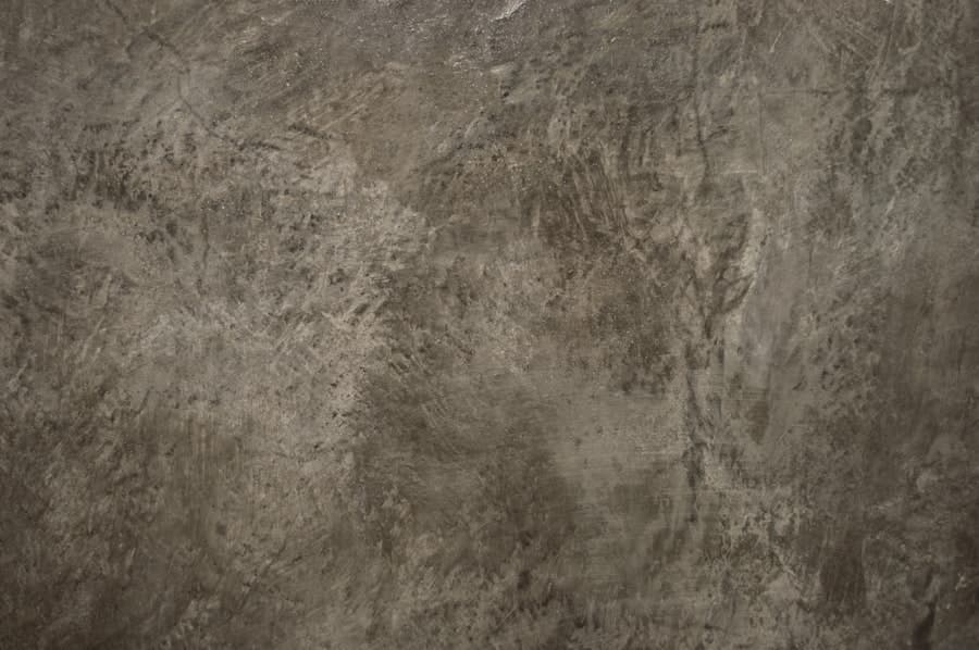 Mottled brown and grey acid-stained concrete surface texture